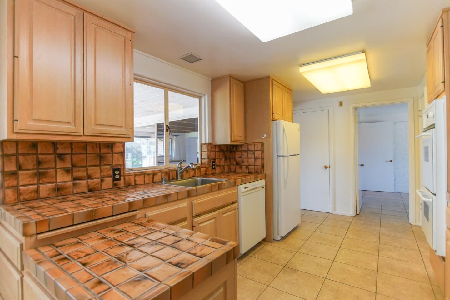 1521 Cienega Road Hollister, CA 95023 - Photo 41 of 56 a kitchen with stainless steel appliances granite countertop a refrigerator and a sink