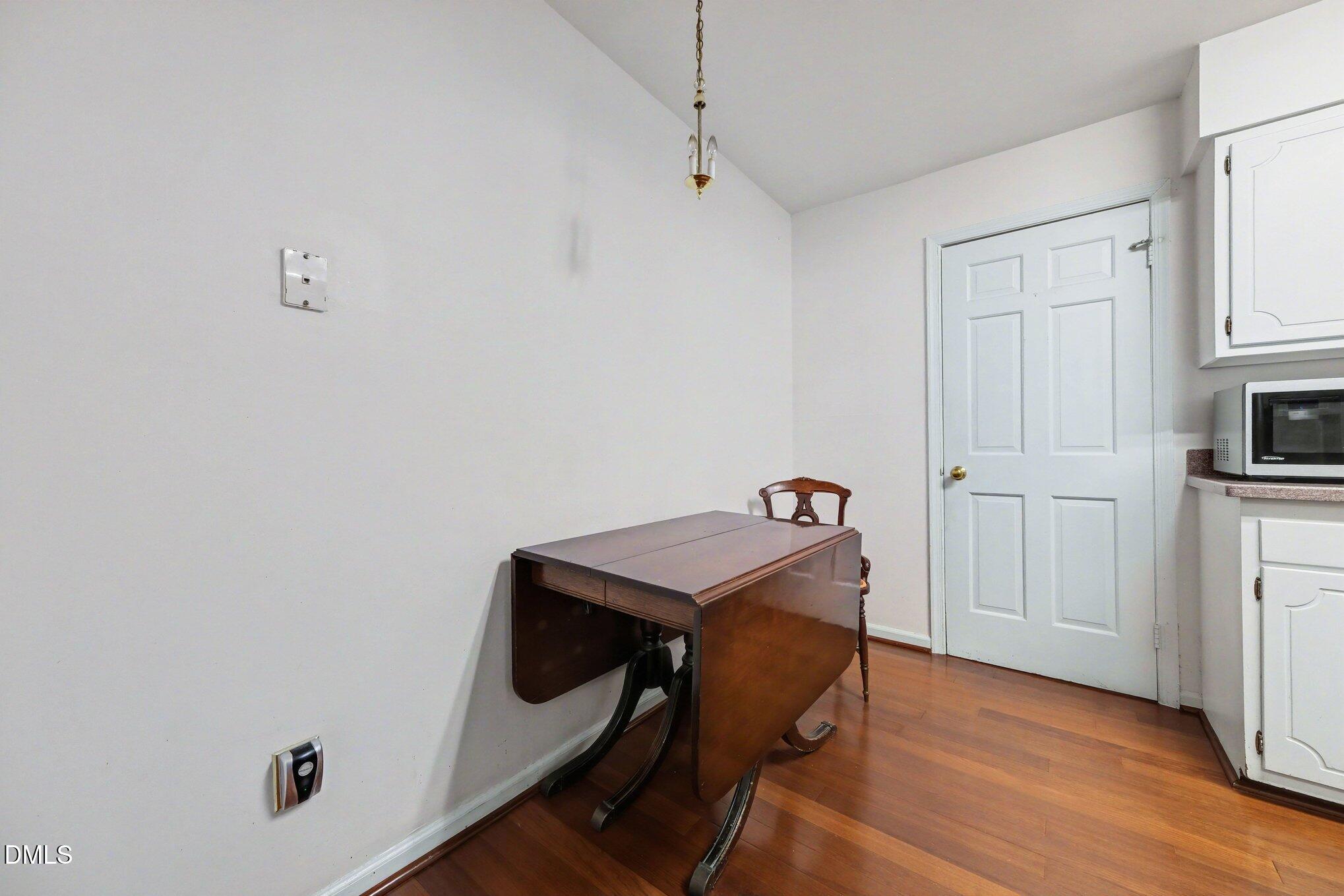 1911 Front Street, Unit 3B Durham, NC 27705 - Photo 11 of 33 a room with a desk and chandelier