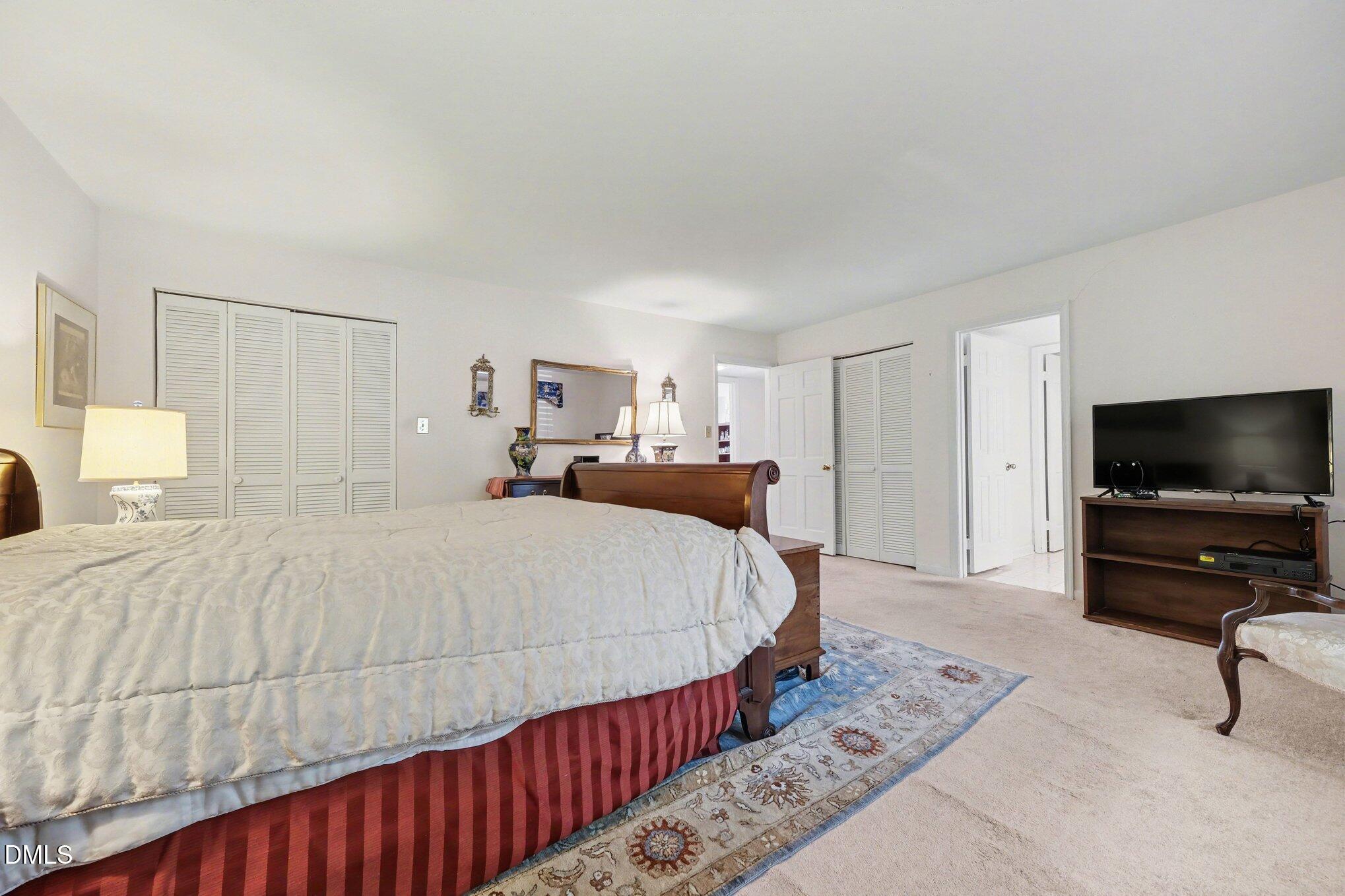 1911 Front Street, Unit 3B Durham, NC 27705 - Photo 15 of 33 a bed room with a bed a flat screen tv and a couch