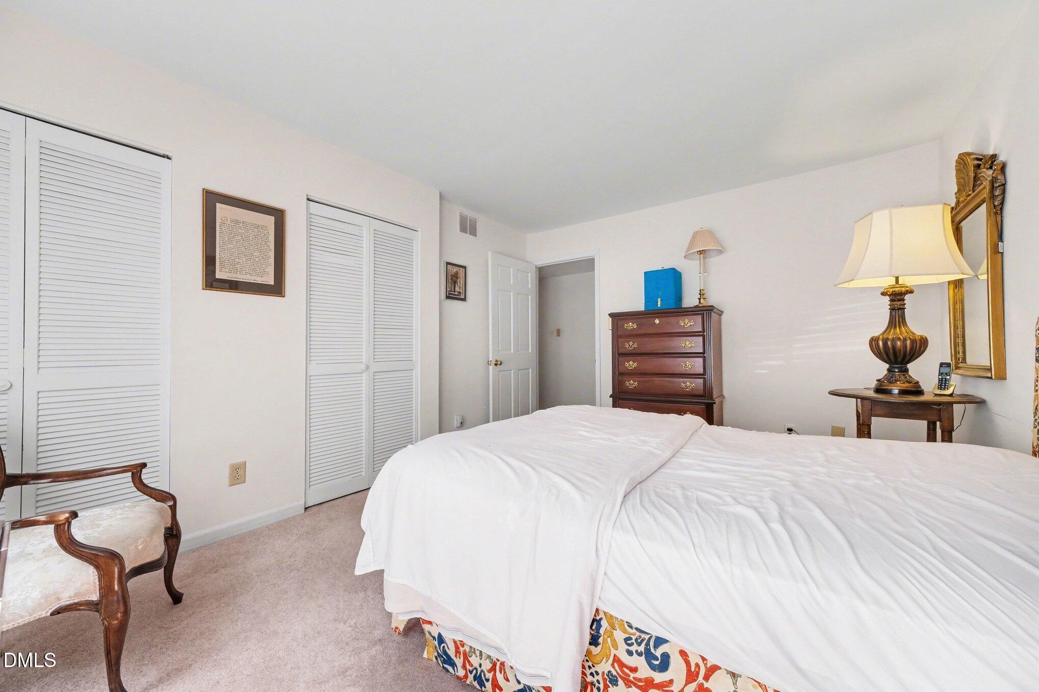 1911 Front Street, Unit 3B Durham, NC 27705 - Photo 18 of 33 a bedroom with a bed and chair