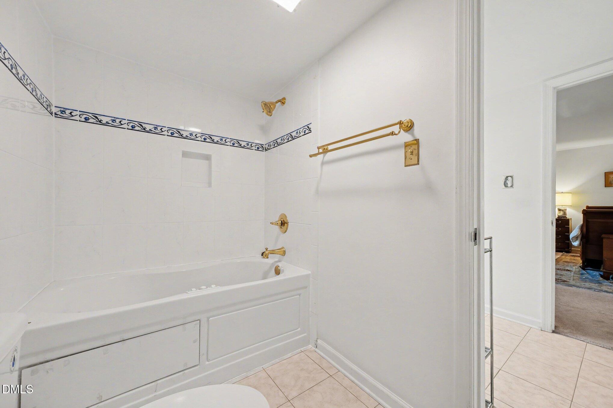 1911 Front Street, Unit 3B Durham, NC 27705 - Photo 22 of 33 a bathroom with a shower and a bath tub