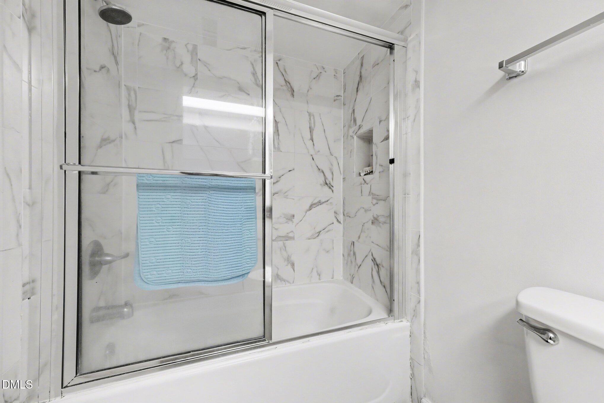 1911 Front Street, Unit 3B Durham, NC 27705 - Photo 23 of 33 a bathroom with a glass shower door