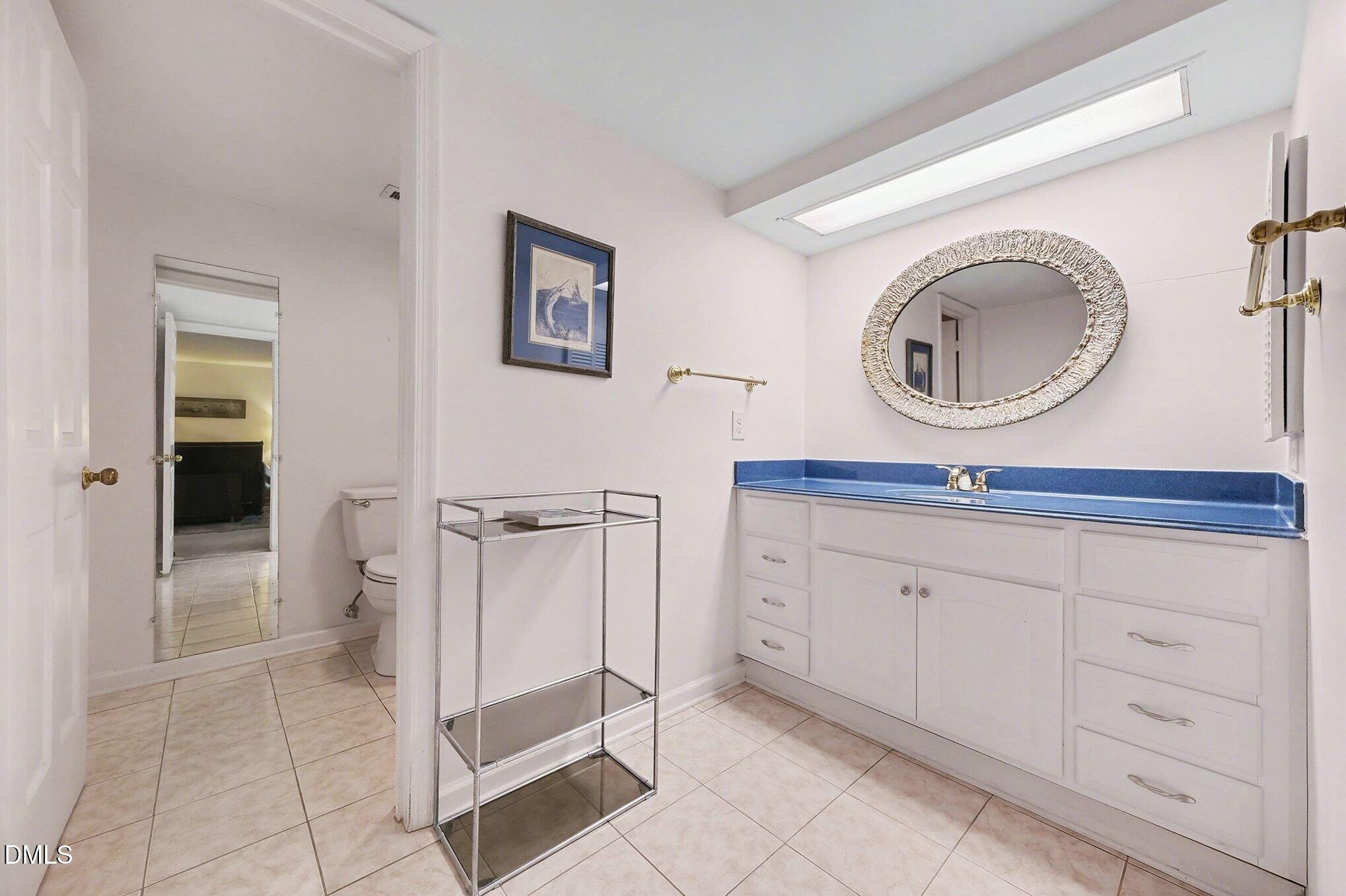 1911 Front Street, Unit 3B Durham, NC 27705 - Photo 25 of 33 a spacious bathroom with a mirror and a sink