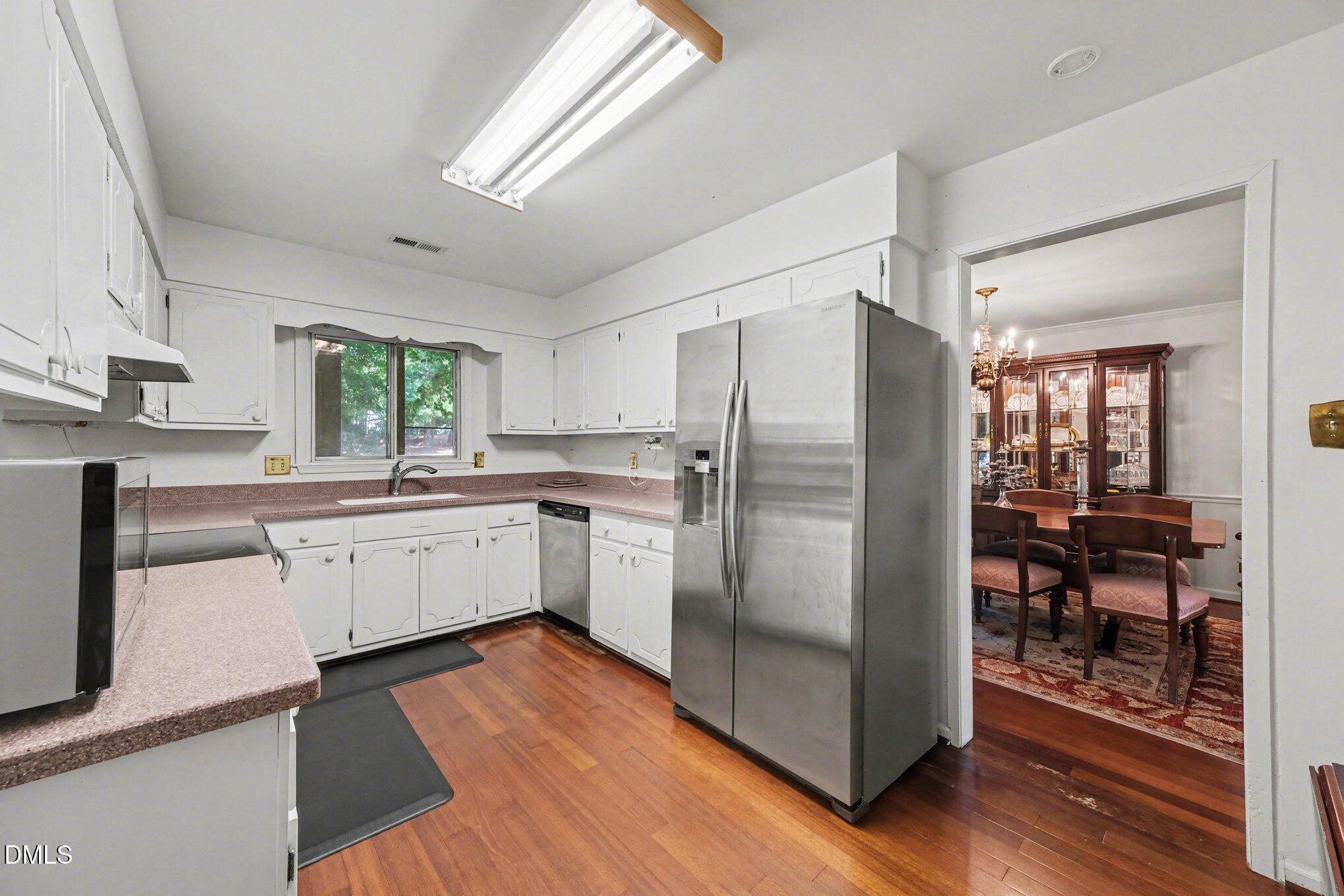 1911 Front Street, Unit 3B Durham, NC 27705 - Photo 7 of 33 a kitchen with stainless steel appliances a refrigerator sink and stove