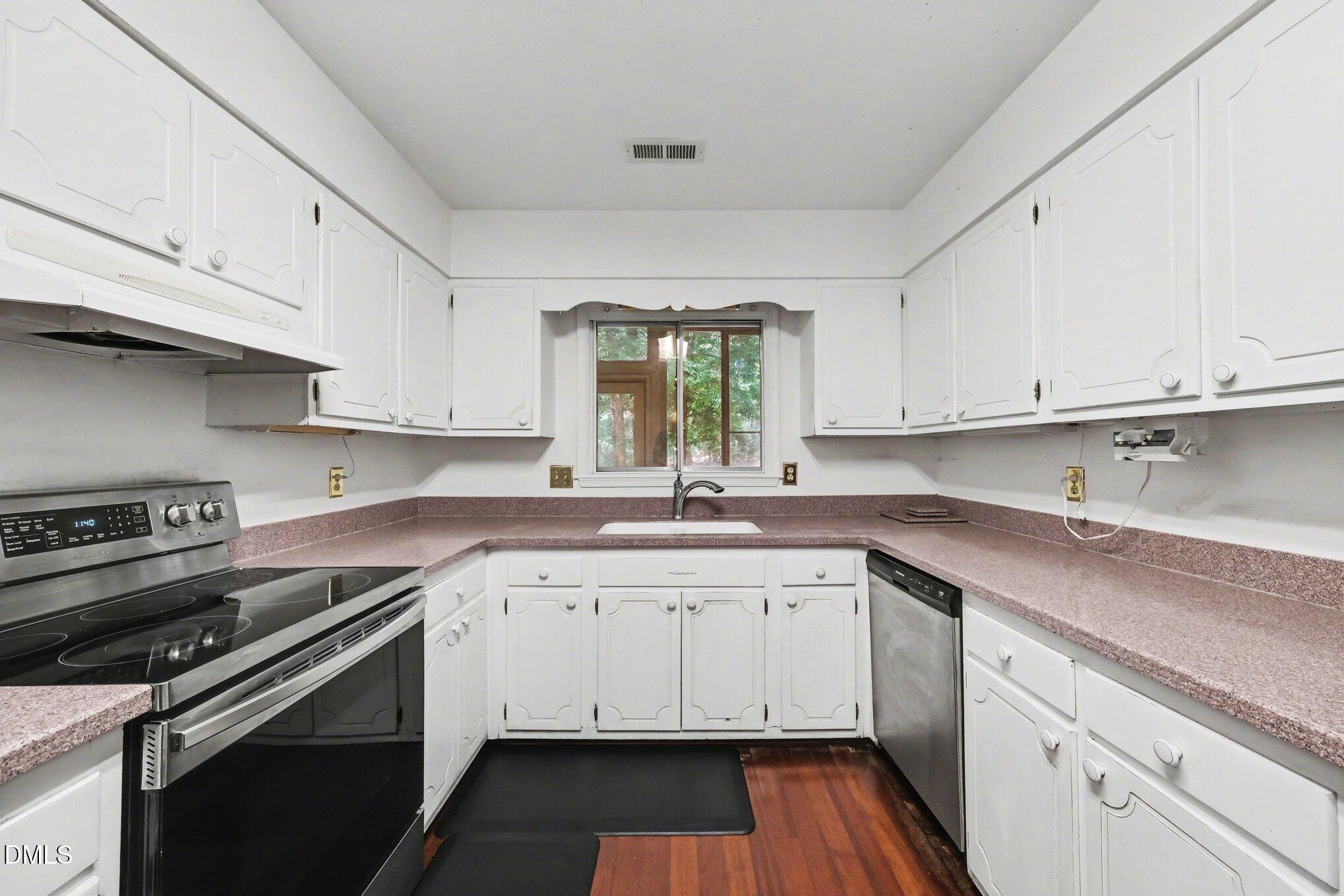 1911 Front Street, Unit 3B Durham, NC 27705 - Photo 8 of 33 a kitchen with a sink stove and cabinets