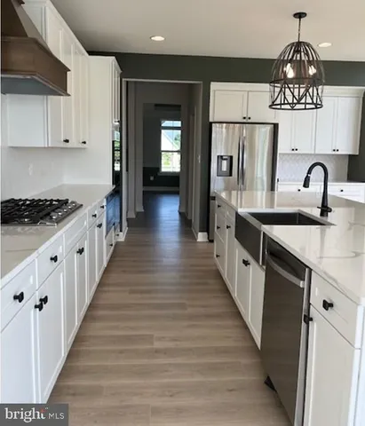a kitchen with a sink stove and chairs