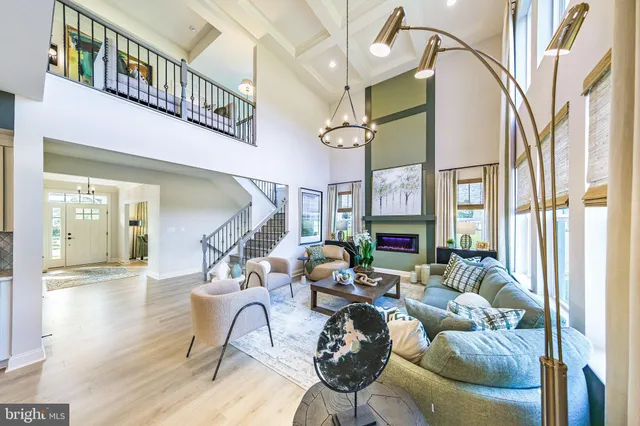 a living room with furniture a fireplace and a chandelier