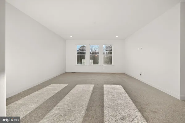 a view of an empty room with windows