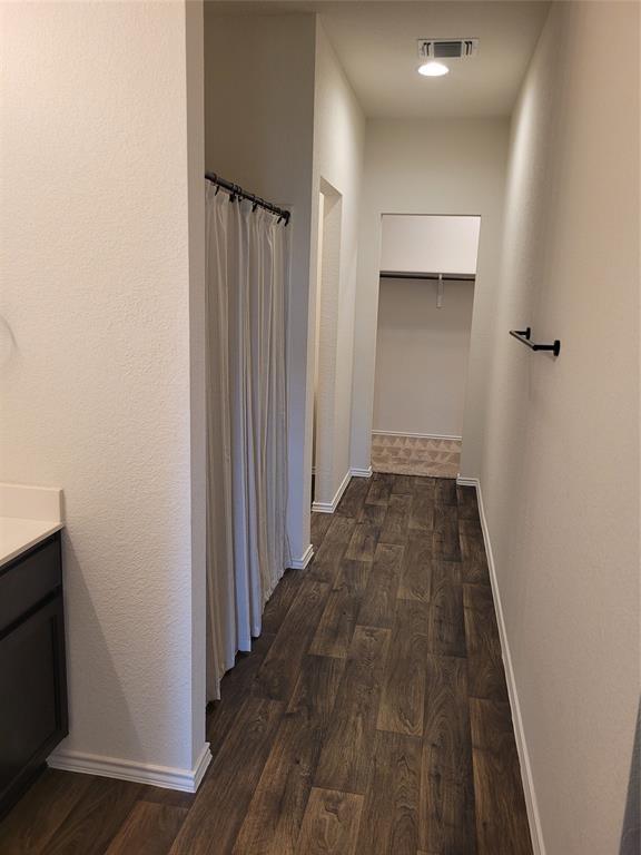14917 Gypsum Mill Road Manor, TX 78653 - Photo 23 of 28 Rich hardwood floors lead to an open closet, optimizing storage and visual flow.