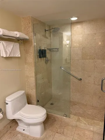 a bathroom with a toilet and a shower