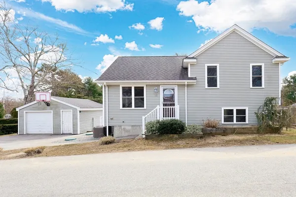 a view of a house with a yard and tree