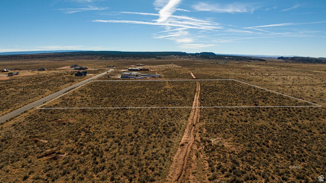 11 Crimson Road East, Unit 11 Kanab, UT 84741 - Photo 14 of 21 Aerial view of sparsely populated area featuring a mountain backdrop and a desert landscape