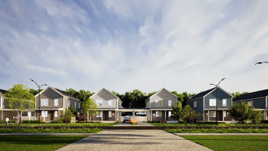 25 Adams Circle, Unit B Devens, MA 01434 - Photo 21 of 22 a front view of residential houses with yard and green space