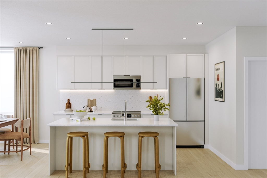 25 Adams Circle, Unit B Devens, MA 01434 - Photo 3 of 22 a kitchen with white cabinets and refrigerator