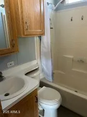 a living room with fireplace furniture and a rug