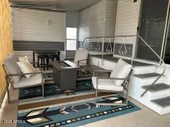 a living room with fireplace furniture and a rug