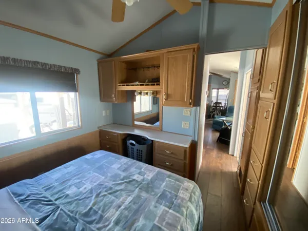 a bedroom with a bed and a large window