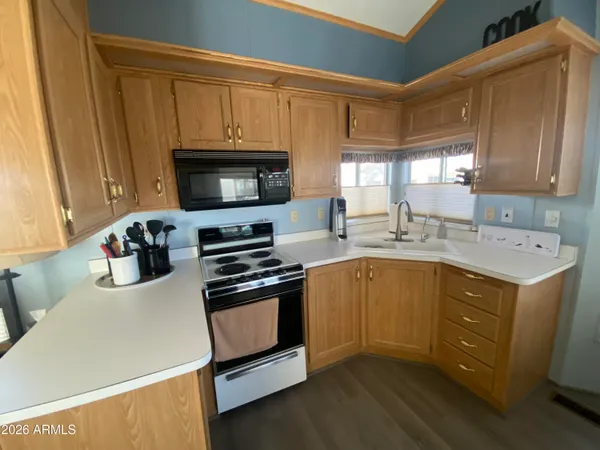 a kitchen with a sink a stove and cabinets