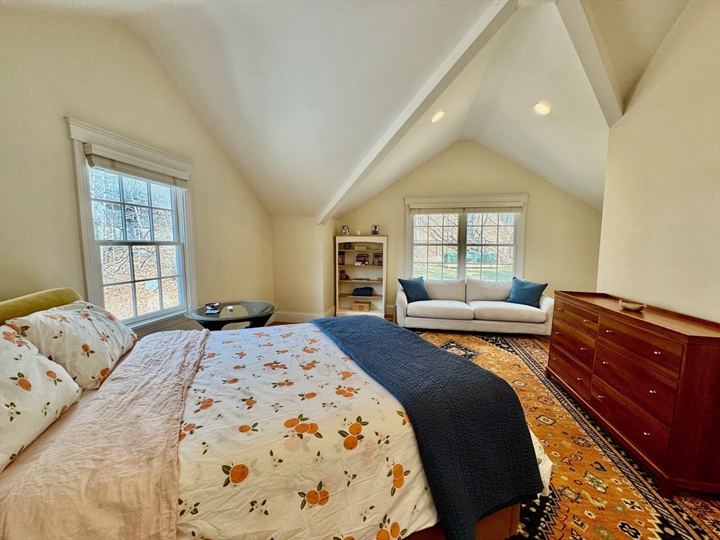 601 Lexington Road Concord, MA 01742 - Photo 8 of 16 a bedroom with a bed and wooden floor