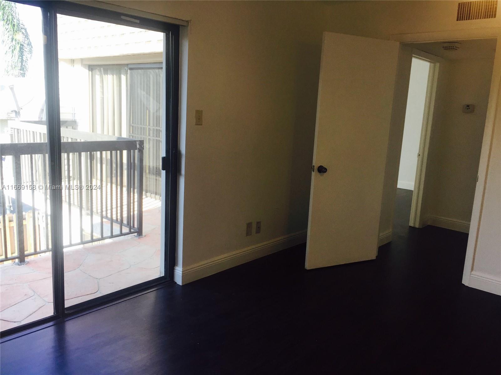8205 Southwest 23rd Court, Unit 21A North Lauderdale, FL 33068 - Photo 12 of 23 a view of a hallway with wooden floor and a window