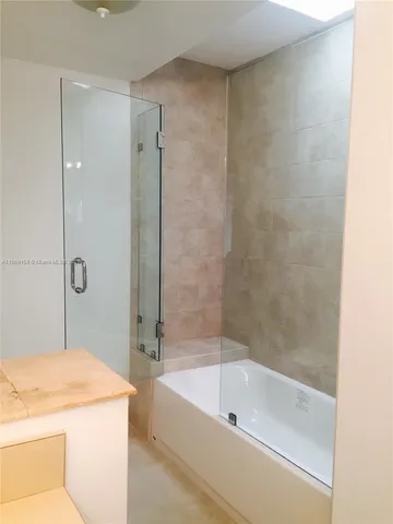 a bathroom with a sink a mirror and a bathtub