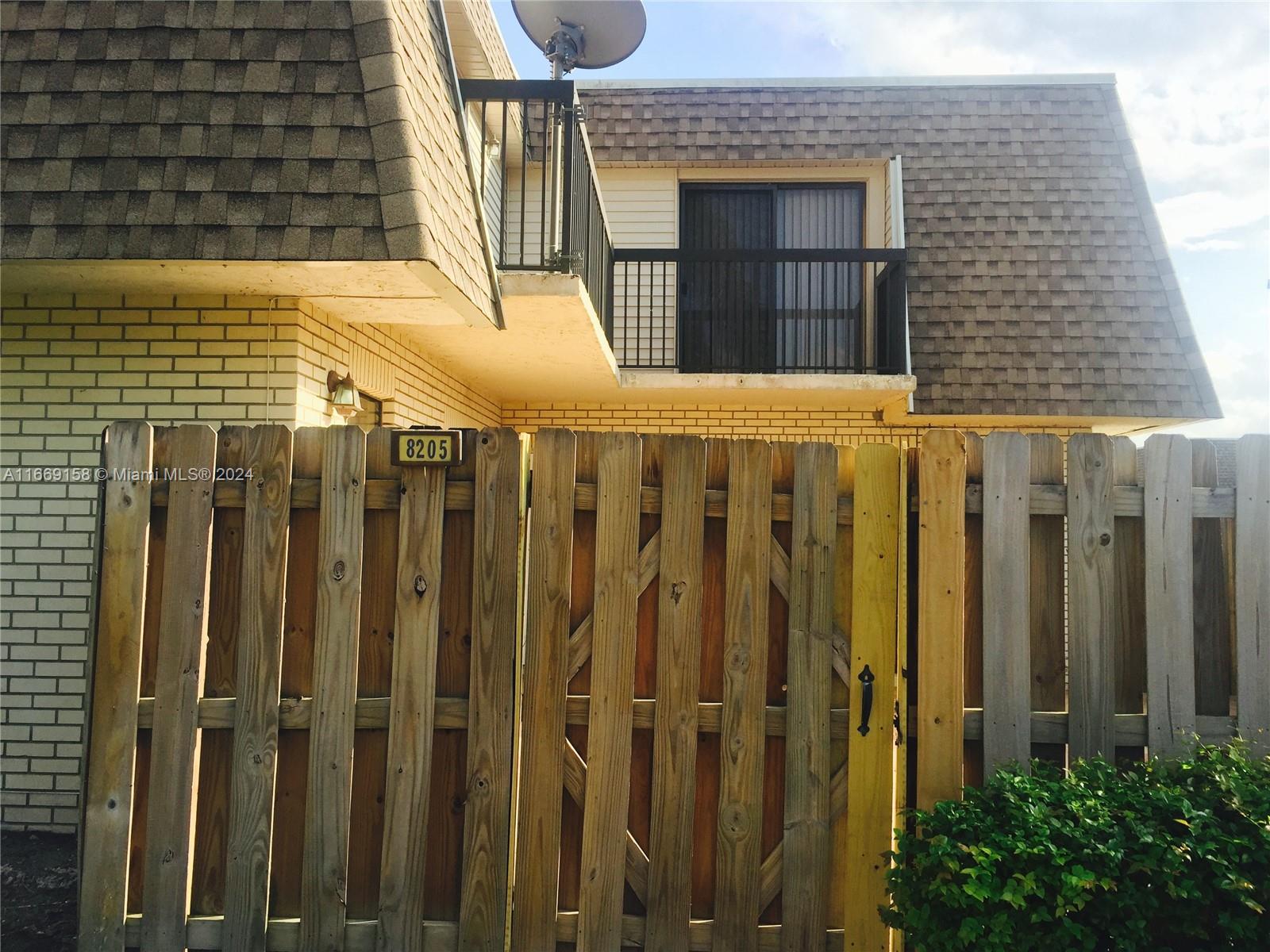 8205 Southwest 23rd Court, Unit 21A North Lauderdale, FL 33068 - Photo 21 of 23 a view of a house with wooden fence