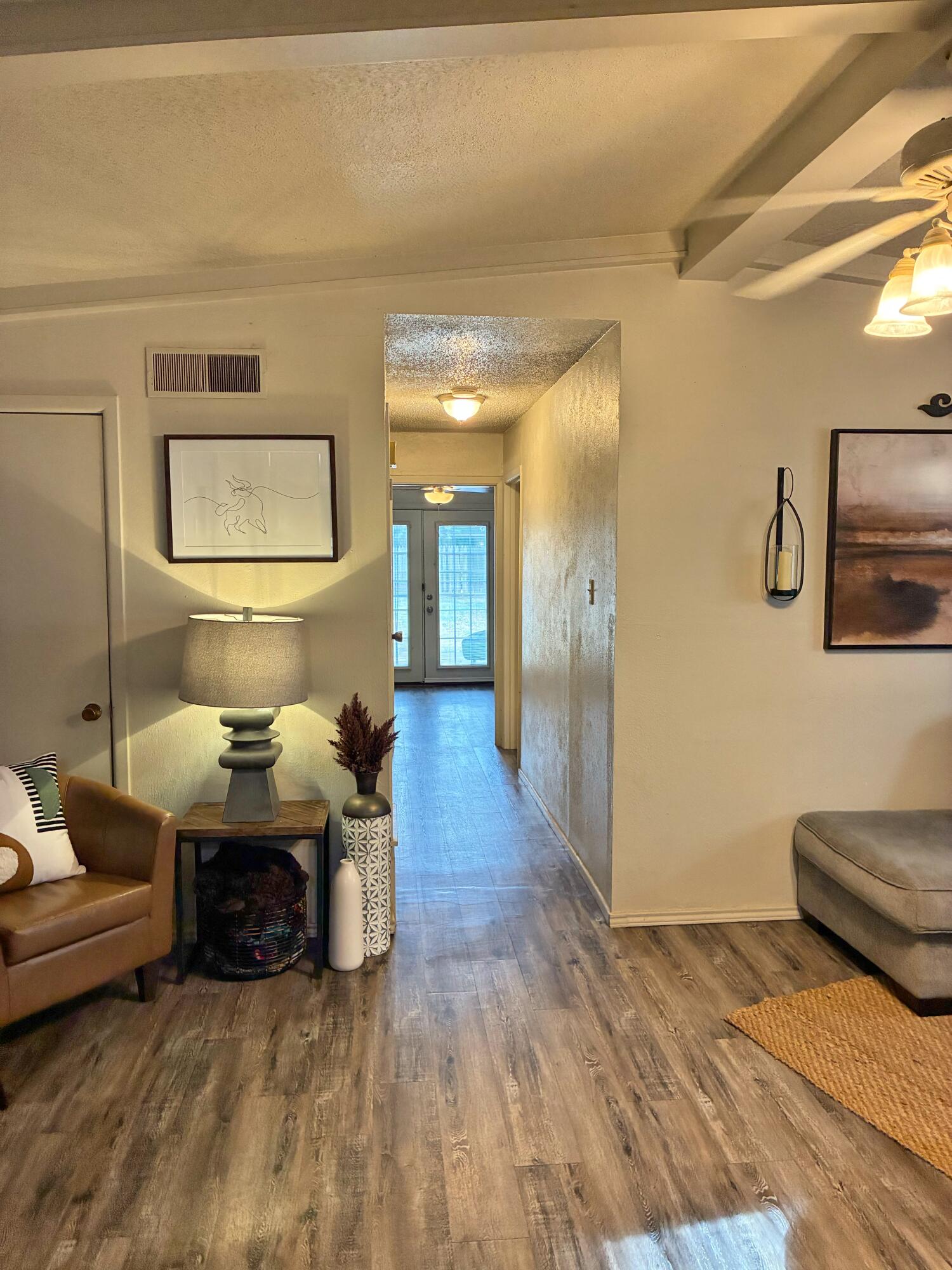 4203 17th Street Lubbock, TX 79416 - Photo 9 of 15 a living room with furniture and a wooden floor