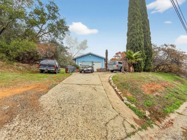 a view of a house with a yard and garage