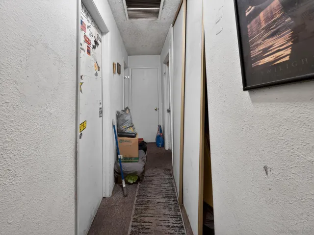 a hallway with kids room with the entryway