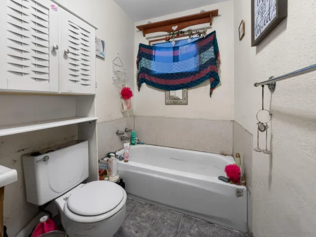 a bathroom with a toilet a sink and bathtub
