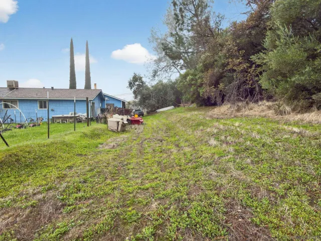 a backyard of a house with table and chairs