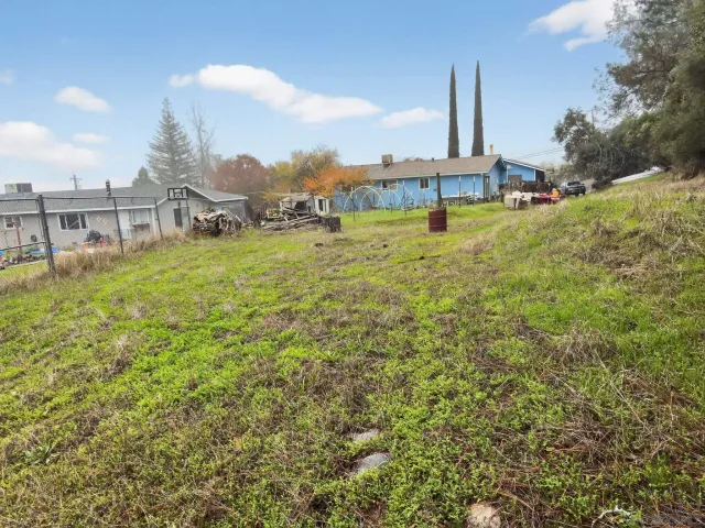 a view of a garden with a building in the background