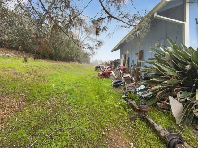 a backyard of a house with table and chairs
