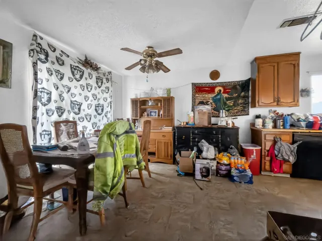 a view of a room with shelves and a chandelier