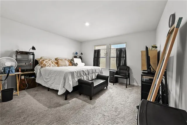 a bedroom with a bed and a television in it