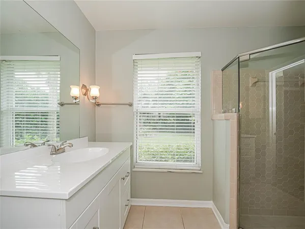 a bathroom with a sink double vanity and a shower