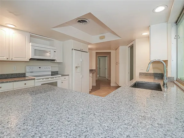 a kitchen with refrigerator and cabinets