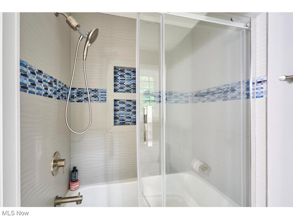1570 Shade Road Akron, OH 44333 - Photo 25 of 45 Bathroom with shower / bath combination with tiled walls and glass door