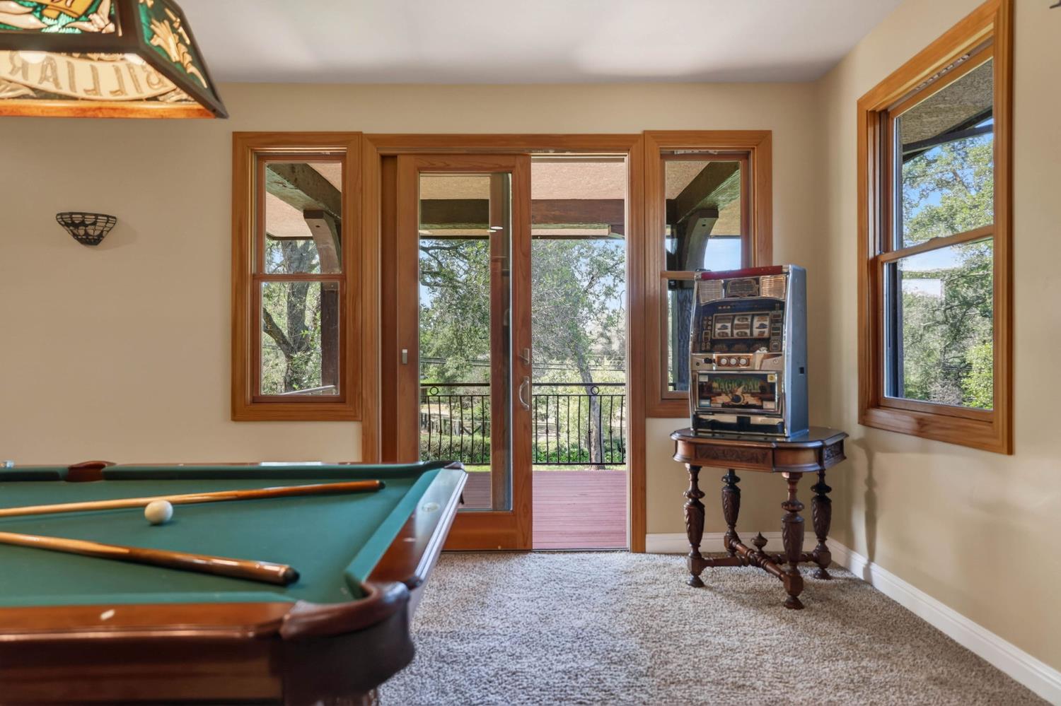 7021 Horseshoe Bar Road Loomis, CA 95650 - Photo 33 of 77 Plush carpeting and warm-toned walls define this space, featuring extensive natural wood trim around windows and glass panel doors