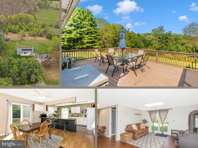 an aerial view of a houses with a yard and lake view