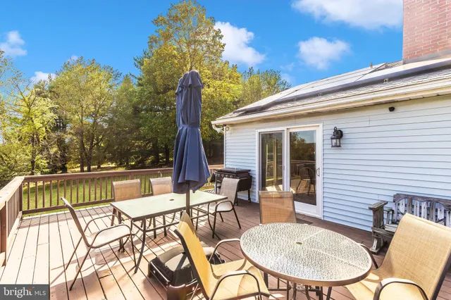 aerial view of a house with a yard and large tree