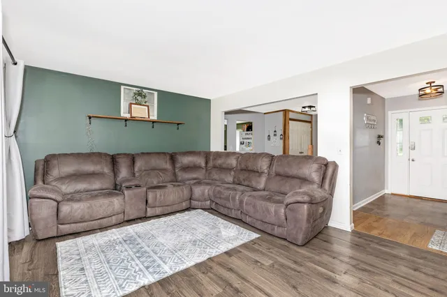 a kitchen with cabinets appliances and wooden floor