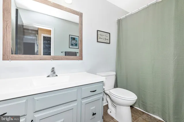 a living room with furniture fireplace and a large window