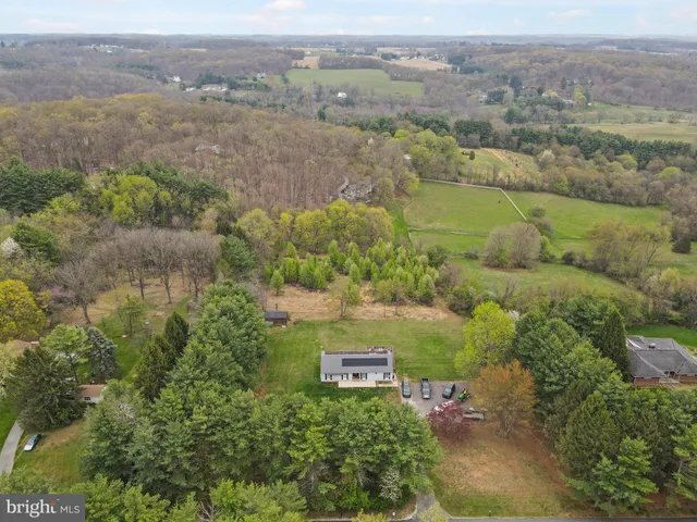 a front view of a house with a garden and outdoor seating