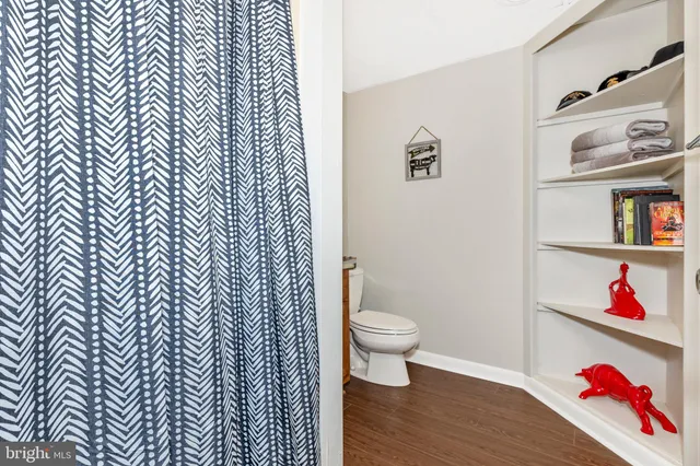 a bedroom with two beds and a lamp on the dresser