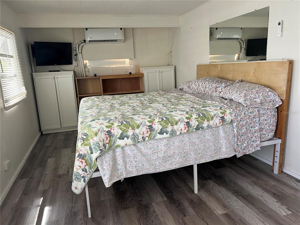 5325 Boca Raton Avenue Sarasota, FL 34234 - Photo 11 of 50 a bedroom with a bed and flat screen tv