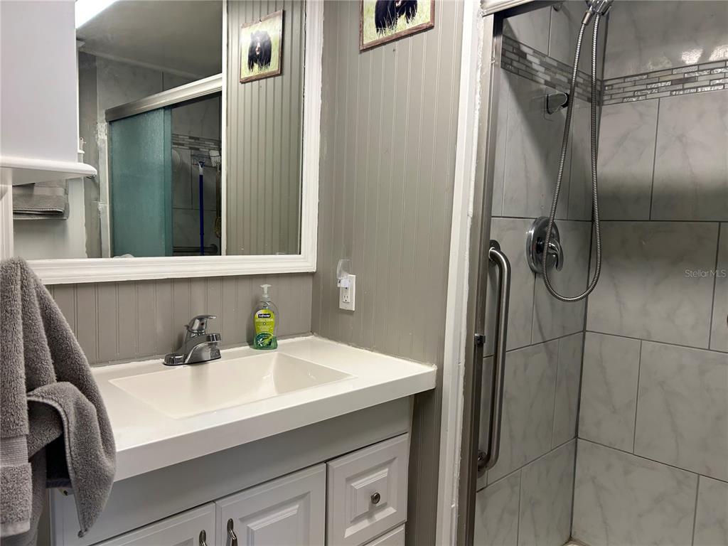 5325 Boca Raton Avenue Sarasota, FL 34234 - Photo 15 of 50 a bathroom with a sink and mirror