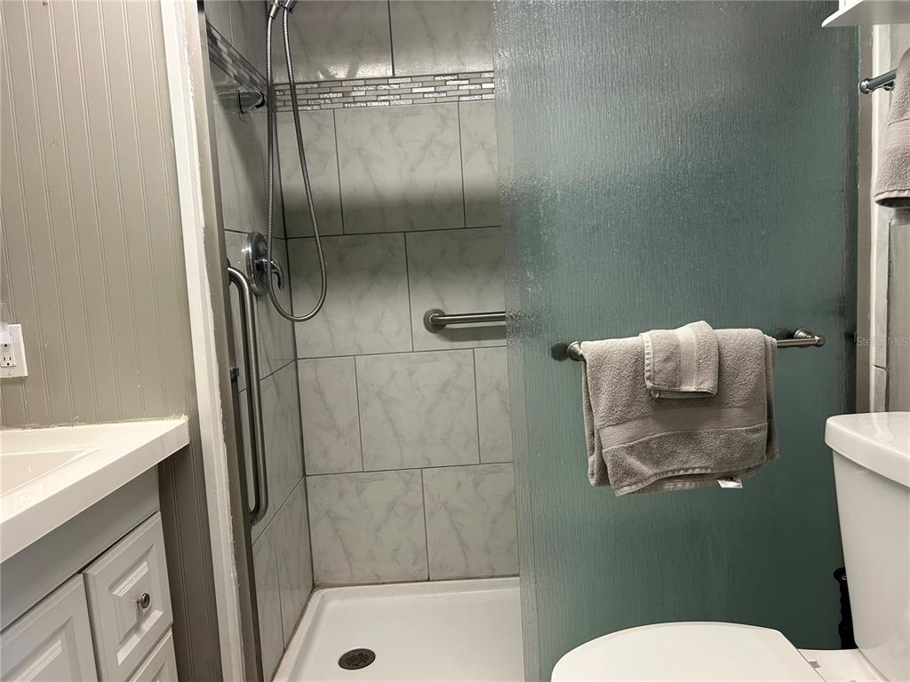 5325 Boca Raton Avenue Sarasota, FL 34234 - Photo 16 of 50 a bathroom with a granite countertop shower a toilet and a sink