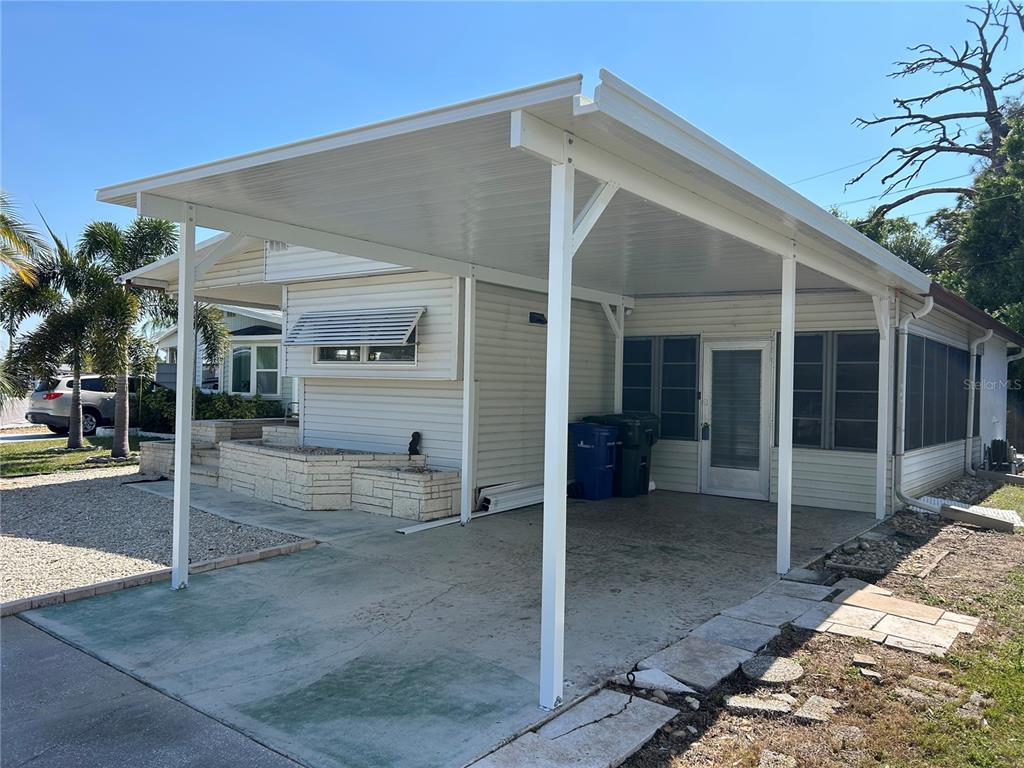 5325 Boca Raton Avenue Sarasota, FL 34234 - Photo 24 of 50 front view of a house with a glass door