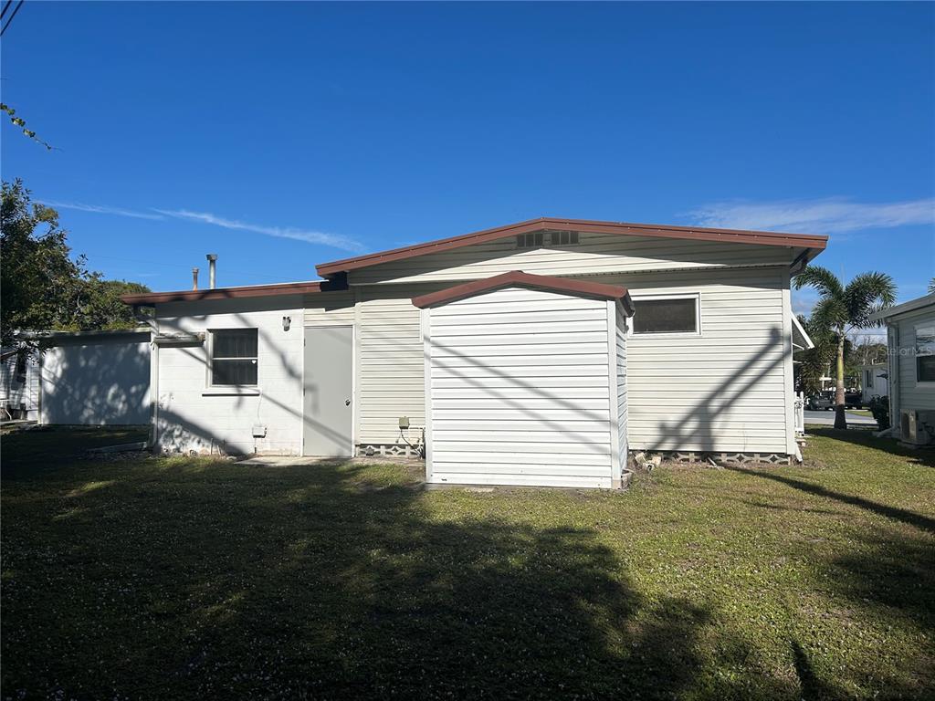 5325 Boca Raton Avenue Sarasota, FL 34234 - Photo 28 of 50 a view of a white house with a yard